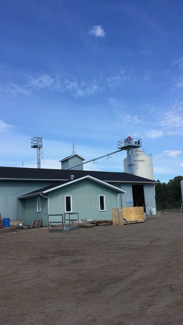 Exterior bin and conveyor beside the existing building