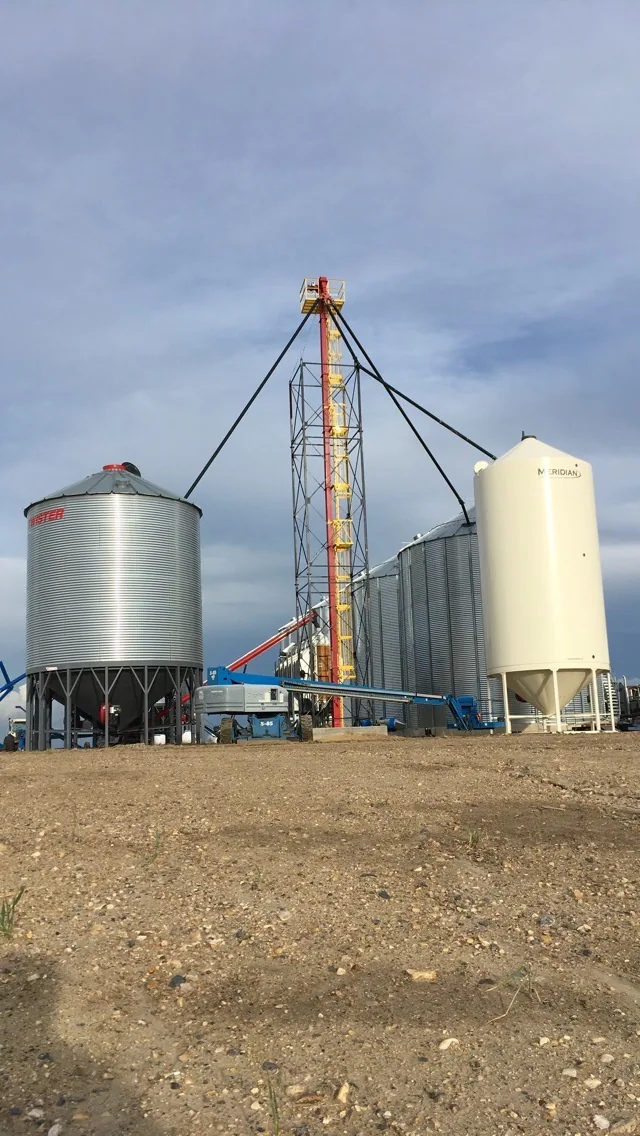 Bucket elevator tower beside the dryer and bins